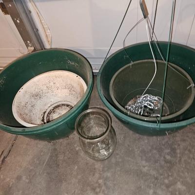 Hanging flowerpots with an assortment of other pots