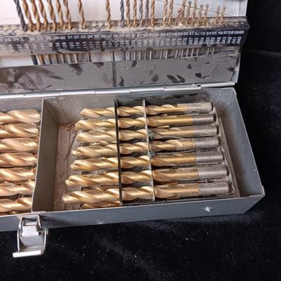 METAL HINGED BOX FULL OF FOLD UP DRILL BITS