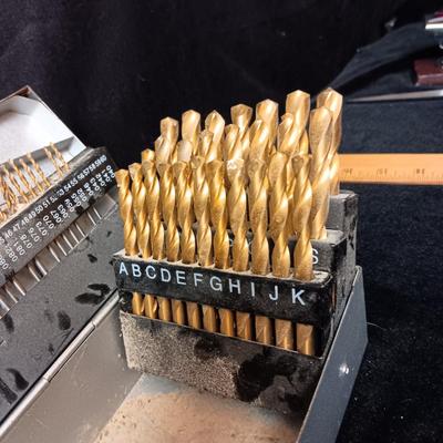 METAL HINGED BOX FULL OF FOLD UP DRILL BITS