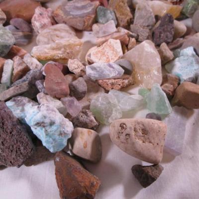 Decorative rocks, some polished with glass container