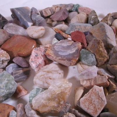 Decorative rocks, some polished with glass container