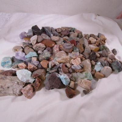 Decorative rocks, some polished with glass container