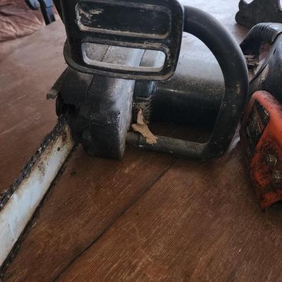 Pair of chain saws.