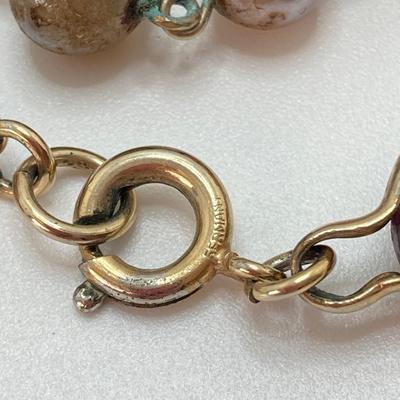 LOT 324: Opera Length Faux Glass Pearls, Lariat Gold Tone Chain with Rhinestones and Four Strand Green Faux Pearls