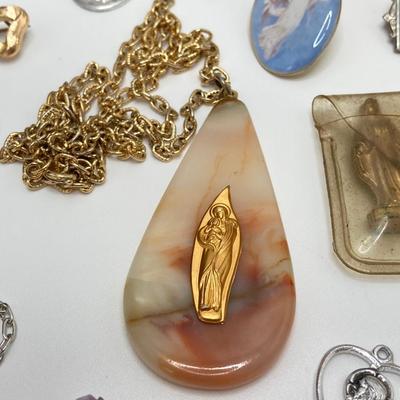 LOT 609: Religious Collection - Stone Pendant w/Gold Tone Chain, Crystal Heart Pendant w/Cross, Red Enamel & Rhinestone Guardian...