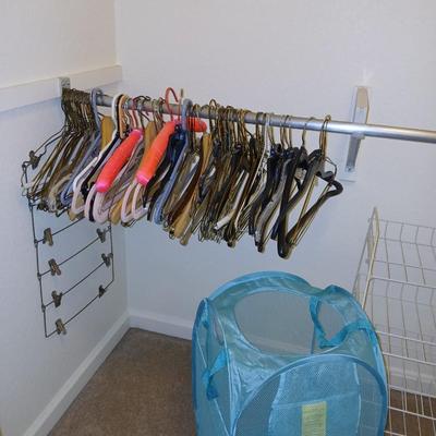 Metal shelf for organizing closet, Mesh laundry hamper and a bunch of coat hangers
