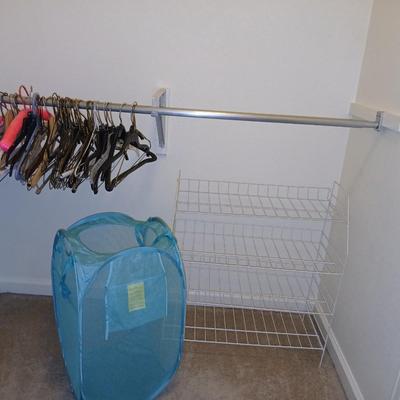 Metal shelf for organizing closet, Mesh laundry hamper and a bunch of coat hangers