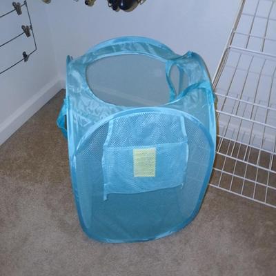Metal shelf for organizing closet, Mesh laundry hamper and a bunch of coat hangers