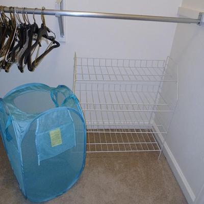 Metal shelf for organizing closet, Mesh laundry hamper and a bunch of coat hangers