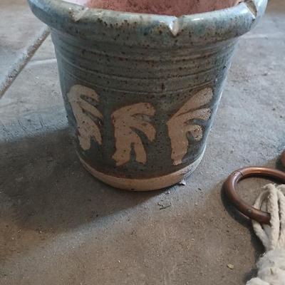 Two pottery flowerpots with three macramé plant hangers