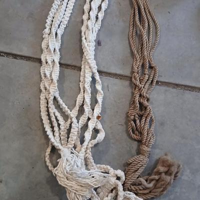 Two pottery flowerpots with three macramé plant hangers