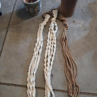 Two pottery flowerpots with three macramé plant hangers