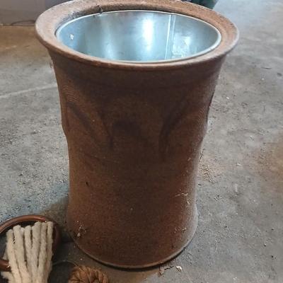 Two pottery flowerpots with three macramé plant hangers