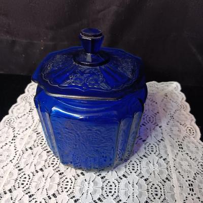 COBALT BLUE GLASS CANISTER W/LID, SMALL PITCHER AND 2 GLASS CUPS WITH RAISED BIRD DESIGN