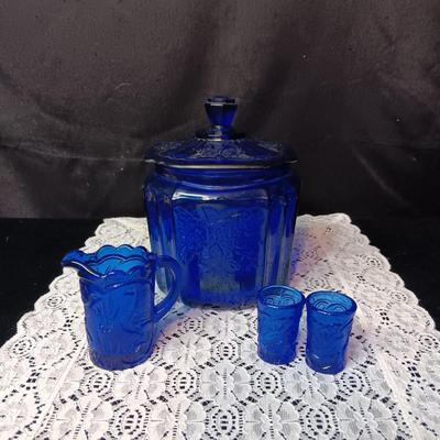 COBALT BLUE GLASS CANISTER W/LID, SMALL PITCHER AND 2 GLASS CUPS WITH RAISED BIRD DESIGN