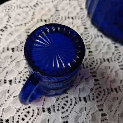 COBALT BLUE GLASS CANISTER W/LID, SMALL PITCHER AND 2 GLASS CUPS WITH RAISED BIRD DESIGN