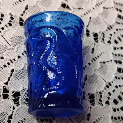COBALT BLUE GLASS CANISTER W/LID, SMALL PITCHER AND 2 GLASS CUPS WITH RAISED BIRD DESIGN