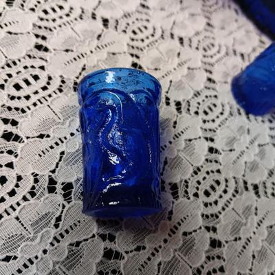 COBALT BLUE GLASS CANISTER W/LID, SMALL PITCHER AND 2 GLASS CUPS WITH RAISED BIRD DESIGN