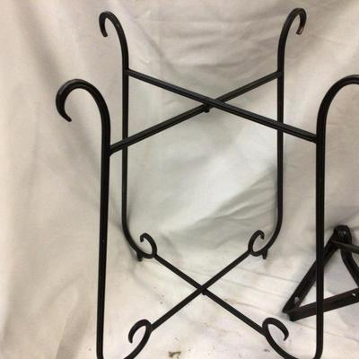 Sale Photo Thumbnail #602: You get a great set of cast iron folding table legs, and two metal plant holders.