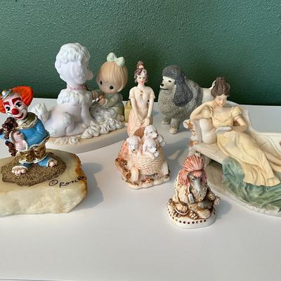 Grouping of figurines including a clown signed by Ron 80