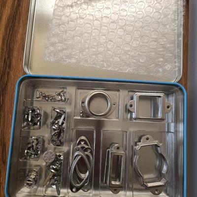 Hodgepodge Hardware and Crafting Paper in a Storage Container