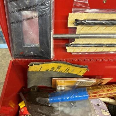 Red metal toolbox with tools
