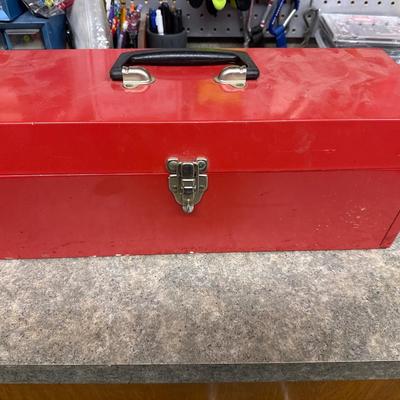 Red metal toolbox with tools