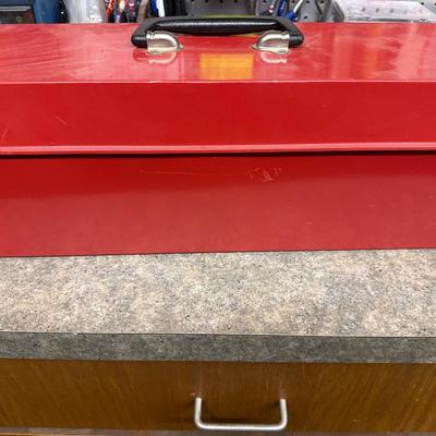 Red metal toolbox with tools