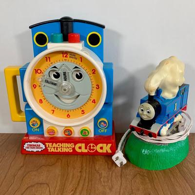 LOT 40 A: Thomas The Tank Engine Collection; Teaching Talking Clock, Happiness Express Portable Lamp, VHS's, DVD, Curtains, Flat...