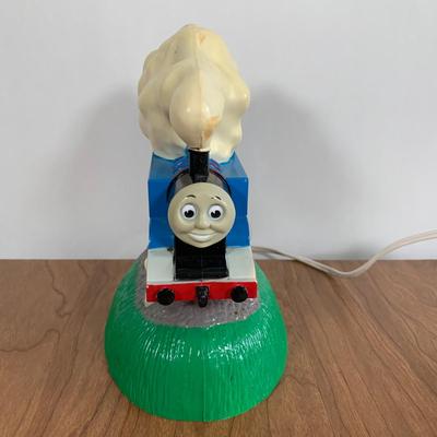 LOT 40 A: Thomas The Tank Engine Collection; Teaching Talking Clock, Happiness Express Portable Lamp, VHS's, DVD, Curtains, Flat...