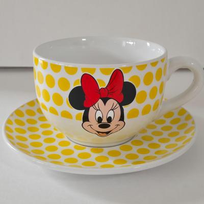 LOT 124B: Mickey Mouse Head Shaped Cutting Board, Metal Trivet, Bowls with Mickey's Feet, Minnie Mouse Cup and Saucer, and Minnie...