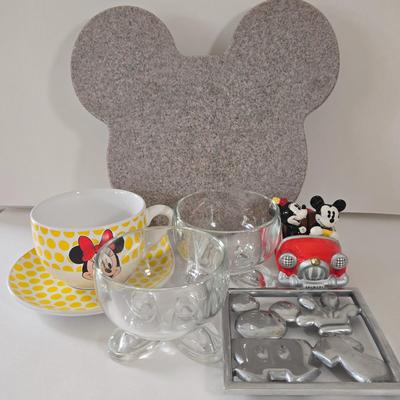 LOT 124B: Mickey Mouse Head Shaped Cutting Board, Metal Trivet, Bowls with Mickey's Feet, Minnie Mouse Cup and Saucer, and Minnie...