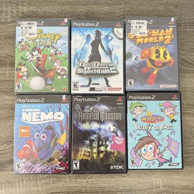 LOT 193A: PlayStation 2 PS2 Video Games: NIP Disney Golf, NIP DDR Super Nova 2, NIP Pac Man World 2, NIP Finding Nemo Game, Disney's...