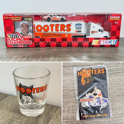 LOT 239B: Hooters Collection: Racing Champions NASCAR 2002 1:64 Transporter and Die-Cast Stock Car, Shot Glass & Motorcycle Pin
