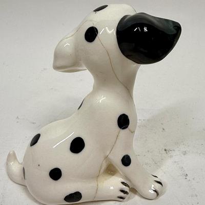 Sale Photo Thumbnail #454: A ceramic figurine inspired by the Disney Studios animated film "101 Dalmatians." Featuring Spot, one of Pongo and Perdita’s puppies, the figurine was produced by Enesco. Figurines like this were sold as souvenirs at Disneyland Park. Measuring 5”x2.25