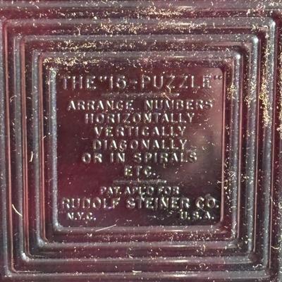 LOT 404 Well Loved Antique Toy Collection: Rudolph Steiner Co. The 15 Puzzle Bakelite Game w/Storage, Composition Doll, Nosey Hound...