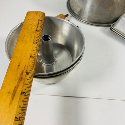 LOT444: Vintage Uranium Glass Measuring Cup, Mini Wood Rolling Pins, Mini Cake Pans, Mini Bunt Cake Pans and a Glass Hen on a Nest