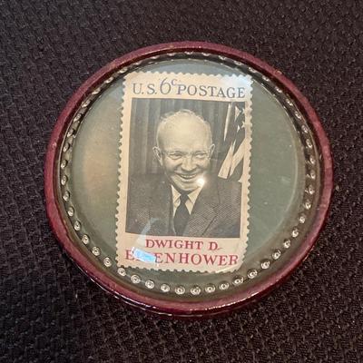 6 cent D. Eisenhower stamp under magnifying glass