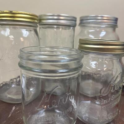 Collection of vintage canning jars including Atlas, Kerr and ball