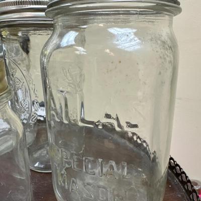 Collection of vintage canning jars including Atlas, Kerr and ball