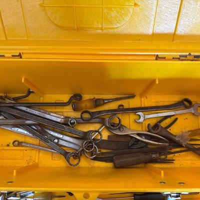 Yellow plastic toolbox with hand tools