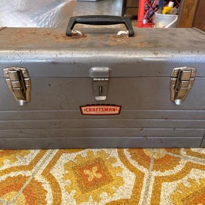 Gray metal craftsman toolbox with hand tools