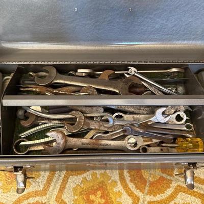 Gray metal craftsman toolbox with hand tools