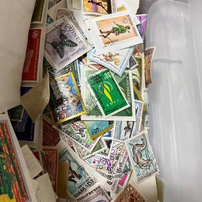 Small tote of hundreds of postmarked stamps