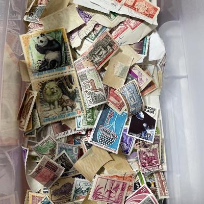 Small tote of hundreds of postmarked stamps