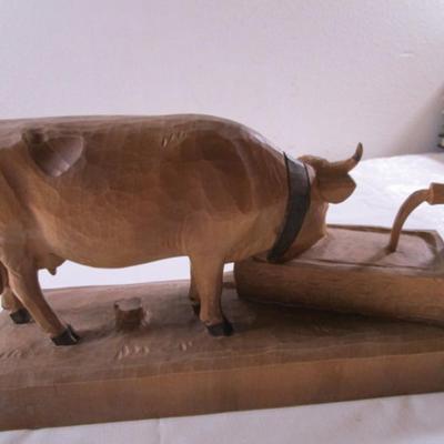 Hand-carved wooden cow sculpture