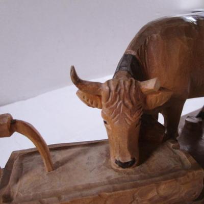 Hand-carved wooden cow sculpture