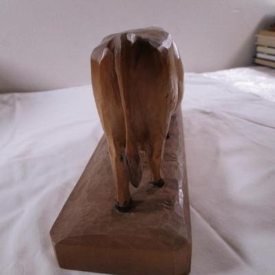 Hand-carved wooden cow sculpture