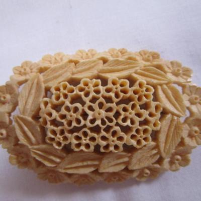 Antique carved bovine bone brooch