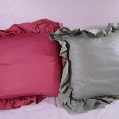 2 decorative ruffled pillows